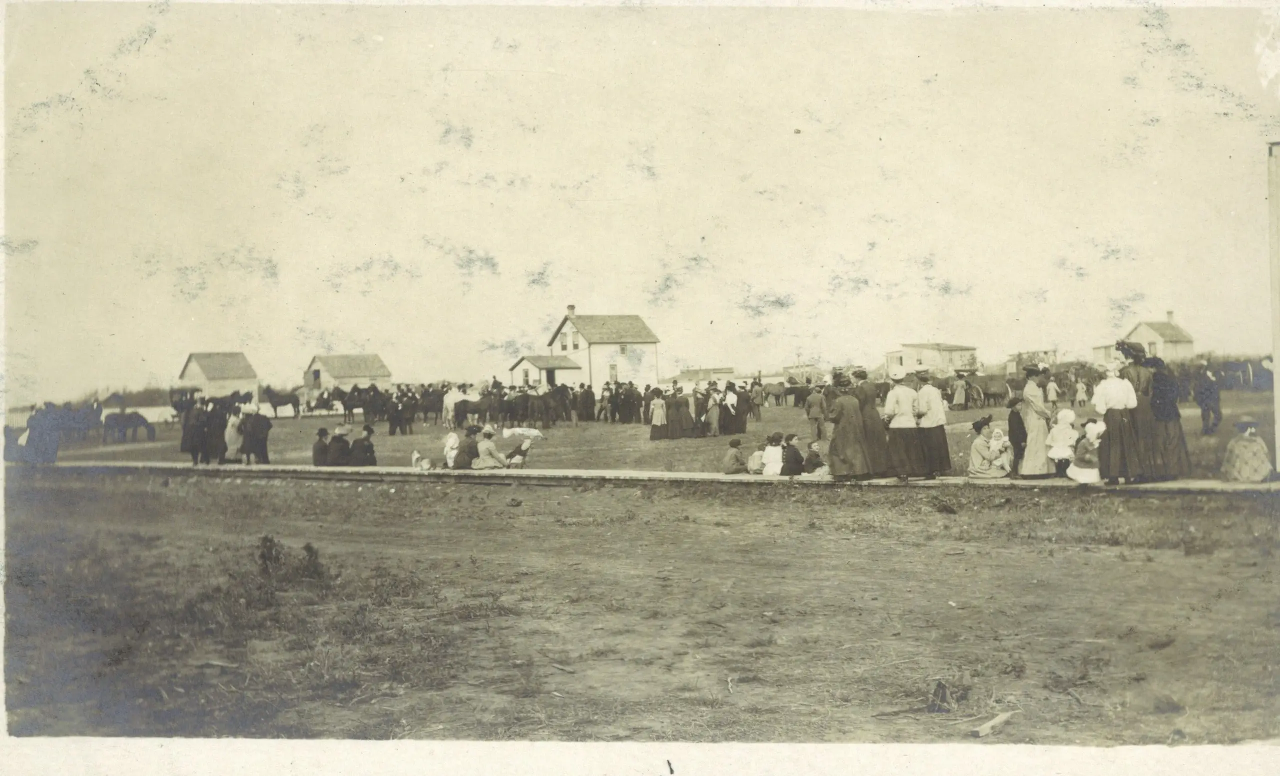 Crowd gathered at an event on the prairie
